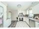Updated kitchen featuring stainless steel appliances, tile backsplash, white cabinets, and gray countertops at 901 N Greenbriar Rd, Muncie, IN 47304