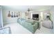 Bright living room with a large sectional couch, ceiling fan, and electric guitar display at 901 N Greenbriar Rd, Muncie, IN 47304