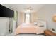 Main bedroom featuring a mounted television, ceiling fan, natural light, and neutral decor at 901 N Greenbriar Rd, Muncie, IN 47304