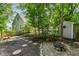 Backyard with a fire pit, landscaping, and path leading to the house and shed at 908 Queensbury Dr, Noblesville, IN 46062