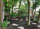 Lush backyard with stone pathways and mature trees, creating a serene and private outdoor space at 908 Queensbury Dr, Noblesville, IN 46062