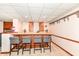 Basement bar with stylish seating, wooden cabinets, and a cozy atmosphere, perfect for gatherings at 908 Queensbury Dr, Noblesville, IN 46062