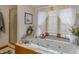 Relaxing bathroom featuring a large tub, soft natural lighting from a window, and a separate shower at 908 Queensbury Dr, Noblesville, IN 46062