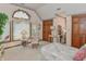 Bright and cheerful bedroom with vaulted ceilings, a large window, and a comfortable seating area at 908 Queensbury Dr, Noblesville, IN 46062