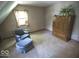 Attic bedroom featuring an accent chair with ottoman and a large bureau at 908 Queensbury Dr, Noblesville, IN 46062