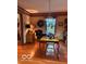 Traditional dining area features hardwood floors, a vintage light fixture, a wooden table and natural light at 908 Queensbury Dr, Noblesville, IN 46062
