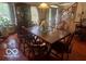 Dining room with hardwood floors features a large wood table with seating for six and natural light at 908 Queensbury Dr, Noblesville, IN 46062