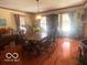 The dining room is bright and sunny with natural light, features a hutch, and classic wood table at 908 Queensbury Dr, Noblesville, IN 46062