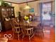 Traditional dining room with a hutch, a wood table with seating, and a large window at 908 Queensbury Dr, Noblesville, IN 46062