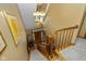 Elegant foyer view from above the stairs, featuring hardwood floors and a chandelier, creating a grand entrance at 908 Queensbury Dr, Noblesville, IN 46062