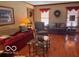 Inviting living room with wood floors, traditional furnishings, and ample natural light from the windows at 908 Queensbury Dr, Noblesville, IN 46062