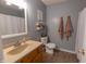 Bathroom featuring a vanity, toilet, towels, and decorative shelves at 939 Arabian Way, Bargersville, IN 46106