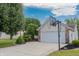 Well-manicured front yard with driveway leading to an attached two-car garage with basketball hoop at 939 Arabian Way, Bargersville, IN 46106