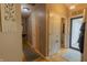 Well-lit hallway with wood floors, neutral walls, and decorative accents, leading to the front entry at 939 Arabian Way, Bargersville, IN 46106