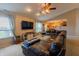 Cozy living room featuring a large sectional, view to the kitchen, and natural light from the window at 939 Arabian Way, Bargersville, IN 46106