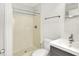 Bright bathroom featuring a shower, toilet, and a modern vanity with a gray cabinet at 944 Briar Patch Ln, Greenwood, IN 46142