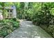 Long driveway framed by retaining walls and mature trees at 944 Briar Patch Ln, Greenwood, IN 46142