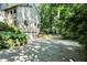 Spacious driveway leading to a unique two-story home surrounded by professionally landscaped retaining walls at 944 Briar Patch Ln, Greenwood, IN 46142