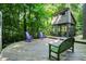 Multi-level home with wooden deck, outdoor furniture, and mature trees at 944 Briar Patch Ln, Greenwood, IN 46142
