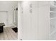 Hallway featuring white built-in cabinets and tile flooring leading to the front door at 944 Briar Patch Ln, Greenwood, IN 46142