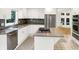 Bright kitchen with granite counters, island cooktop, stainless appliances, and white cabinets at 944 Briar Patch Ln, Greenwood, IN 46142