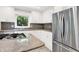 This kitchen features granite counters, stainless appliances, gas cooktop and ample white cabinetry at 944 Briar Patch Ln, Greenwood, IN 46142