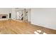 Bright living room with modern fireplace, hardwood floors, and staircase leading to an upper level at 944 Briar Patch Ln, Greenwood, IN 46142