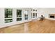 Bright living room with modern fireplace, hardwood floors, and large windows providing ample natural light and views at 944 Briar Patch Ln, Greenwood, IN 46142
