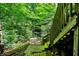 Stairs leading down from deck to the grounds and green forest at 944 Briar Patch Ln, Greenwood, IN 46142