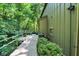 Exterior walkway leading to the house, surrounded by greenery and trees for a private, natural setting at 944 Briar Patch Ln, Greenwood, IN 46142