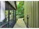 Enclosed walkway provides access to screened porch with exterior view to the surrounding forest at 944 Briar Patch Ln, Greenwood, IN 46142