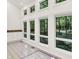 Wet bar and views of lush greenery through multiple windows at 944 Briar Patch Ln, Greenwood, IN 46142