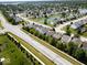 Sprawling suburban neighborhood featuring well-maintained homes, lush greenery, and scenic pond views at 951 Curlew Ln, Greenwood, IN 46143