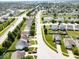 Aerial shot showcasing a neighborhood with well-maintained homes, lush greenery, and a serene pond at 951 Curlew Ln, Greenwood, IN 46143