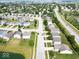Overhead view of a peaceful suburban neighborhood featuring a mix of homes, greenery, and streets at 951 Curlew Ln, Greenwood, IN 46143