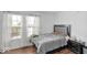 Comfortable bedroom with a large bed, neutral decor, and natural light from the window at 951 Curlew Ln, Greenwood, IN 46143