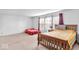 Spacious bedroom with two beds, neutral carpeting, and natural light, perfect for relaxation at 951 Curlew Ln, Greenwood, IN 46143