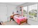 Bright bedroom with a cozy bed, bedside table, and sunlit windows offering a pleasant view at 951 Curlew Ln, Greenwood, IN 46143