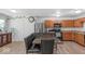Kitchen with an adjacent dining area boasts stainless steel appliances and wood cabinets at 951 Curlew Ln, Greenwood, IN 46143