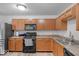 A well-lit kitchen features wood cabinets, stainless steel appliances, and laminate countertops at 951 Curlew Ln, Greenwood, IN 46143