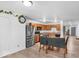 Kitchen with an adjacent dining area boasts stainless steel appliances and wood cabinets at 951 Curlew Ln, Greenwood, IN 46143