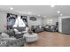 Elegant living room features wood floors, recessed lighting, and matching grey sofas at 951 Curlew Ln, Greenwood, IN 46143