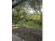 View of a green backyard with trees and a shed at 9550 N Delaware St, Indianapolis, IN 46240