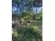 View of the sunny green backyard from behind a mesh screen at 9550 N Delaware St, Indianapolis, IN 46240