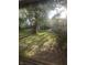 View of the sunny backyard from behind a mesh screen at 9550 N Delaware St, Indianapolis, IN 46240