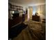 Bedroom with wooden dresser and shelves, plus a large bed with a wolf blanket at 9550 N Delaware St, Indianapolis, IN 46240
