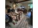 Open dining room area with views to living room, wooden floors, and vintage light fixture at 9550 N Delaware St, Indianapolis, IN 46240