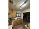 Kitchen with linoleum floors, wooden cabinets, and stainless steel sink at 9550 N Delaware St, Indianapolis, IN 46240