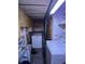 Laundry area with washer and dryer hookups, built-in shelving, and utility sink at 9550 N Delaware St, Indianapolis, IN 46240