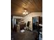 Living room featuring a wooden ceiling, textured floors and abundant natural light from windows at 9550 N Delaware St, Indianapolis, IN 46240